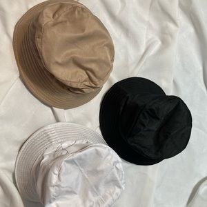 3 bucket hats. Never worn. Tan, black and white